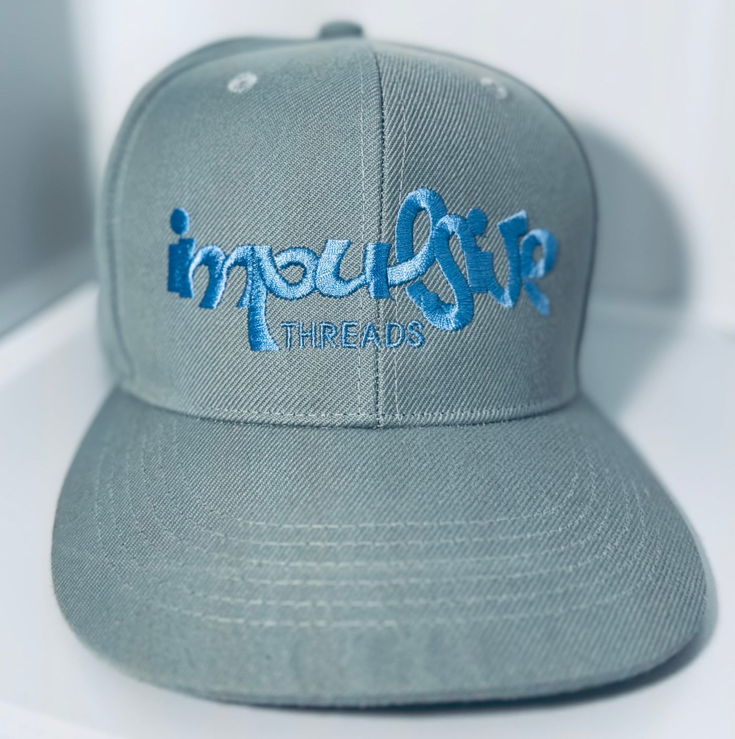 SNAPBACK IMPULSIVE THREADS CAP.